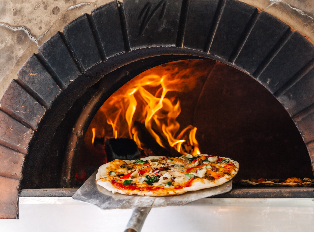 Avella, pizza coming out of pizza oven